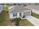 Single-story house with solar panels, garage, and nicely landscaped yard at 1734 Hill Top Dr, Dundee, FL 33838