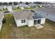 Aerial view of houses with solar panels, showcasing a community at 1734 Hill Top Dr, Dundee, FL 33838