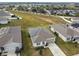 Aerial view of a single-story house with solar panels and a two-car garage at 1734 Hill Top Dr, Dundee, FL 33838