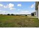 Spacious backyard with grassy area and patio at 1734 Hill Top Dr, Dundee, FL 33838
