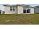 Elevated backyard view of home with patio and surrounding landscape at 1734 Hill Top Dr, Dundee, FL 33838