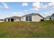 View of home's back elevation and backyard at 1734 Hill Top Dr, Dundee, FL 33838