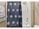 Bathroom with shower/tub combo and patterned shower curtain at 1734 Hill Top Dr, Dundee, FL 33838
