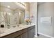 Bathroom with double vanity, large mirror, and shower at 1734 Hill Top Dr, Dundee, FL 33838