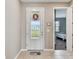 Front entry with decorative door and view to bedroom at 1734 Hill Top Dr, Dundee, FL 33838