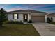 One-story house with a two-car garage and landscaped lawn at 1734 Hill Top Dr, Dundee, FL 33838