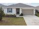 Front view of charming one-story home with garage at 1734 Hill Top Dr, Dundee, FL 33838