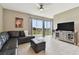 Living room with sectional sofa, ottoman, and sliding glass doors at 1734 Hill Top Dr, Dundee, FL 33838