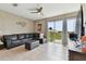 Living room with sectional sofa, ottoman, and sliding glass doors at 1734 Hill Top Dr, Dundee, FL 33838