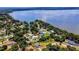 Aerial view showcasing home's waterfront location and neighborhood at 225 Temple Cir, Eustis, FL 32726
