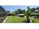 Beautifully landscaped backyard with a covered boat lift on the water, perfect for outdoor living at 225 Temple Cir, Eustis, FL 32726