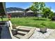 Backyard with mature trees and lush lawn leading to a screened-in pool area at 225 Temple Cir, Eustis, FL 32726