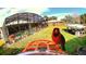 Bird feeder in the backyard with a pool and screen enclosure in the background at 225 Temple Cir, Eustis, FL 32726
