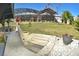 Steps lead to a spacious backyard with a large lawn, shed, and screened patio at 225 Temple Cir, Eustis, FL 32726