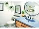 Stylish bathroom featuring shiplap walls, decorative mirror, modern vanity, and patterned tile floor at 225 Temple Cir, Eustis, FL 32726