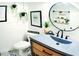 Clean bathroom with gray sink, floating shelves, and patterned floor at 225 Temple Cir, Eustis, FL 32726