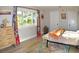 Bright bedroom with large window, dresser, and comfortable bed at 225 Temple Cir, Eustis, FL 32726
