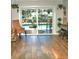 Bright dining area with wood floors, large glass doors leading to a pool, and hanging plants at 225 Temple Cir, Eustis, FL 32726