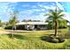 Exterior of the house, showcasing a palm tree and a long driveway at 225 Temple Cir, Eustis, FL 32726