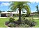 Charming single-story home with a well-manicured lawn and a decorative palm tree in the front yard at 225 Temple Cir, Eustis, FL 32726