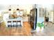 Bright kitchen with white cabinets, stainless steel appliances, and an island with seating at 225 Temple Cir, Eustis, FL 32726