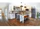 Modern kitchen featuring an island with a wine rack and pendant lighting at 225 Temple Cir, Eustis, FL 32726