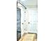 Clean laundry room featuring a stackable washer/dryer, white doors, and wood-look flooring at 225 Temple Cir, Eustis, FL 32726