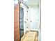 Convenient laundry room with modern appliances and stylish barn door at 225 Temple Cir, Eustis, FL 32726