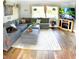 Comfortable living room with a large sectional sofa, stylish decor, and hardwood floors at 225 Temple Cir, Eustis, FL 32726