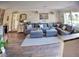 Spacious living room with large sectional sofa, wood floors and large windows at 225 Temple Cir, Eustis, FL 32726