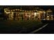 Night view of a screened patio with string lights and fire pit at 225 Temple Cir, Eustis, FL 32726