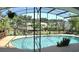 The bright pool is enclosed with a screen, features lush landscaping and greenery, and offers an inviting setting at 225 Temple Cir, Eustis, FL 32726