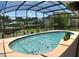 A dazzling pool is nestled inside a screened enclosure, complemented by lush landscaping and abundant greenery at 225 Temple Cir, Eustis, FL 32726
