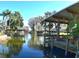 Beautiful water view showcasing boat docks and lush vegetation, creating a peaceful atmosphere at 225 Temple Cir, Eustis, FL 32726