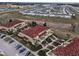 Aerial view of townhouses with red tile roofs and surrounding landscape at 2888 Bella Vista Dr, Davenport, FL 33897