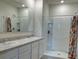 Double vanity bathroom with a walk-in shower and tiled floors at 30364 Armenia Rd, Leesburg, FL 34748