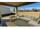 Relaxing covered patio with seating area, overlooking a grassy backyard at 30364 Armenia Rd, Leesburg, FL 34748