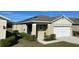 House exterior featuring solar panels and a landscaped front yard at 30364 Armenia Rd, Leesburg, FL 34748