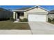 Single-story house with a two-car garage and well-maintained lawn at 30364 Armenia Rd, Leesburg, FL 34748