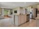 Open-concept kitchen with island, stainless steel appliances, and tile flooring at 30364 Armenia Rd, Leesburg, FL 34748