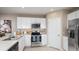 Modern kitchen with white shaker cabinets, stainless steel appliances, and quartz countertops at 1951 Rosewood Cir, Lakeland, FL 33810