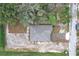 Bird's eye view of a house, showing a gray roof surrounded by dirt and some grassy patches at 2449 Jungle St, Lakeland, FL 33801