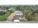 Aerial view of a charming new construction home with a cozy front yard and a freshly paved driveway at 2449 Jungle St, Lakeland, FL 33801