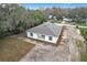 Aerial view of a home, showing a light-colored exterior, dark roof, and surrounding cleared lot at 2449 Jungle St, Lakeland, FL 33801