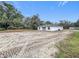 View of a house in a partially cleared lot, showing the side and back of the building at 2449 Jungle St, Lakeland, FL 33801