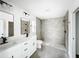 Modern bathroom with a glass-enclosed shower, double vanity, and matte black hardware at 2449 Jungle St, Lakeland, FL 33801