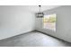 Bright dining room with a modern chandelier, clean white walls, and large window showcasing the outdoors at 2449 Jungle St, Lakeland, FL 33801