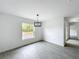 Bright dining room with a modern chandelier, clean white walls, and large window showcasing the outdoors at 2449 Jungle St, Lakeland, FL 33801