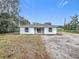 The back of a new, one-story home with white siding and a door leading to the backyard at 2449 Jungle St, Lakeland, FL 33801