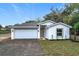 Charming single-story home featuring a two-car garage and freshly landscaped front yard with a modern design at 2449 Jungle St, Lakeland, FL 33801